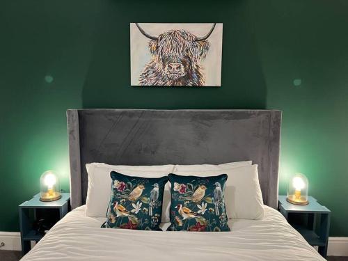 a bedroom with a bed with a cow on the wall at Centralised Horton Place with FREE PARKING by Prescott Apartments in Bristol