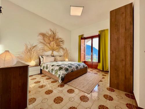 a bedroom with a bed and a large window at Villa Nina Amalfi in Amalfi