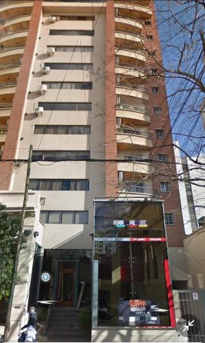 a tallartment building with a glass entrance in front of it at Las diagonales in La Plata