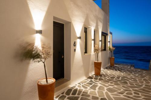 a hallway with a view of the ocean on a building at Portara Seaside Luxury Suites in Naxos Chora