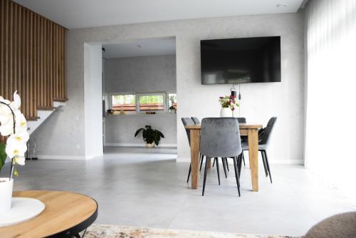 a dining room with a table and chairs at Big Mama Koala in Druskininkai