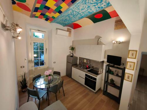 a kitchen with a table and a colorful ceiling at Discover Donatello - Fiorenza in Florence