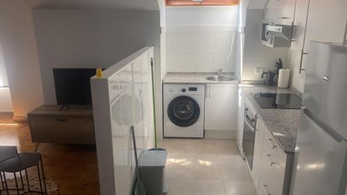 a kitchen with a washing machine and a sink at Valdellera VI in Posada de Llanes