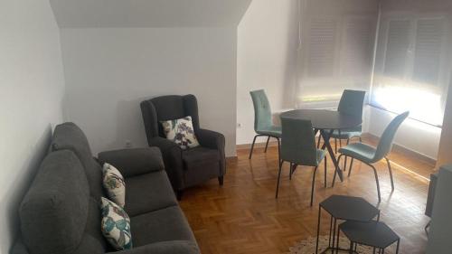 a living room with a couch and a table and chairs at Valdellera VI in Posada de Llanes
