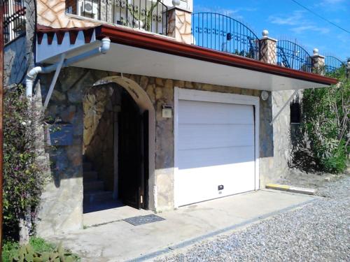 a garage with a white door and a balcony at VILLA KOHLER in Alanya