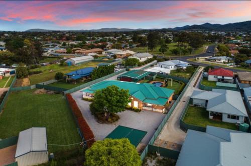 an aerial view of a town with a tennis court at Spacious resort style property with pool in Mudgee - Rest Easy Mudgee Villa in Mudgee