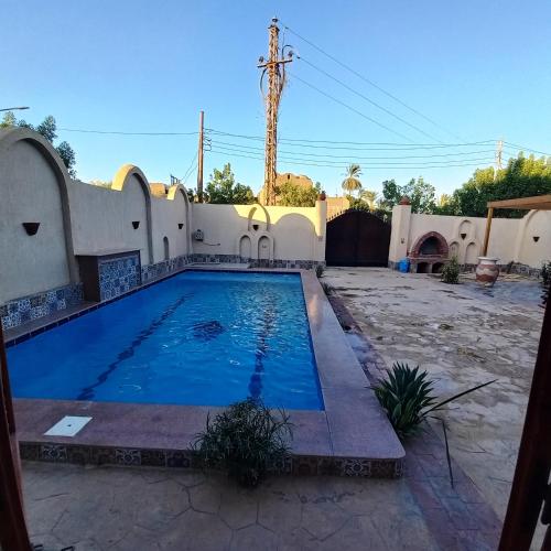 a swimming pool in the backyard of a house at Mystical habou domes villa private pool in Luxor
