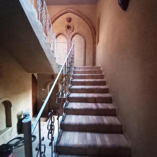 a staircase in an old building with wooden steps at Mystical habou domes villa private pool in Luxor