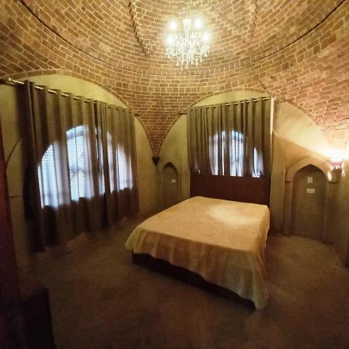 a bedroom with a bed in a room with windows at Mystical habou domes villa private pool in Luxor