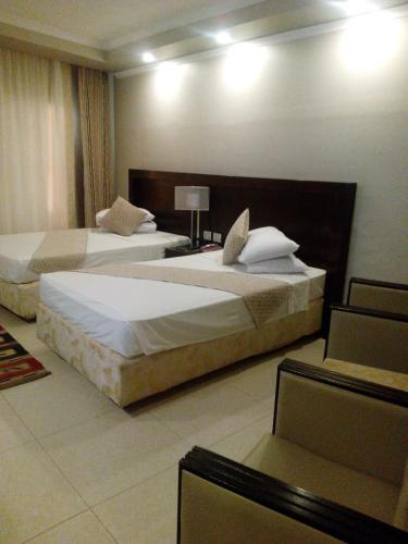 a hotel room with two beds in a room at Salvatore Room With Breakfast- Garden View in Alexandria