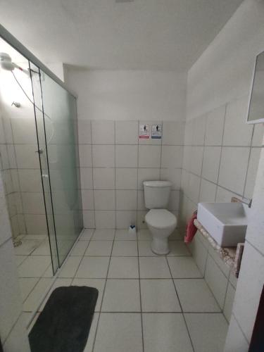 a bathroom with a toilet and a sink at Flat Smart Home in São Luís