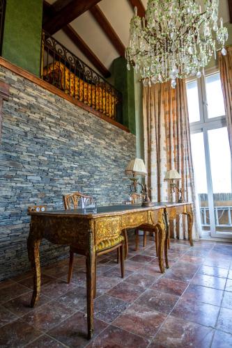 a dining room with two tables and a chandelier at Es Cloper in Cadaqués