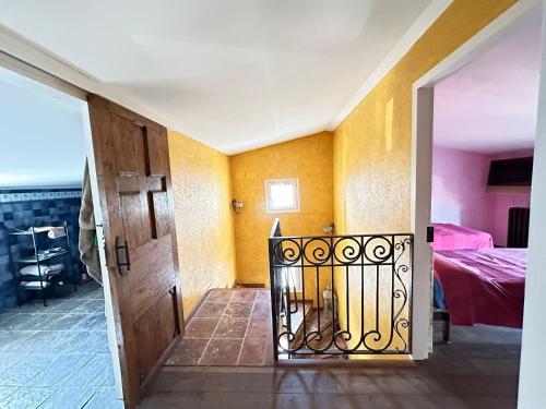 an open door to a room with a bed at Es Cloper in Cadaqués