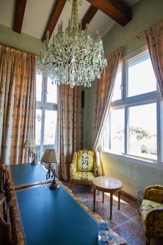 a living room with a pool table and a chandelier at Es Cloper in Cadaqués