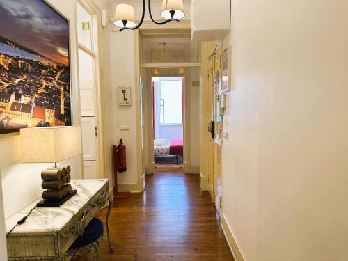 a hallway with a couch and a table in a room at Estrela Charming Rooms by HOST-POINT in Lisbon