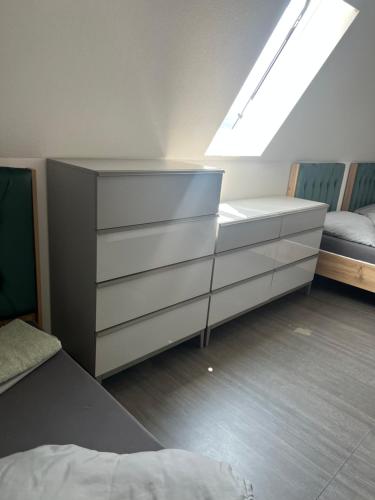 a bedroom with a dresser and a bed and a window at Aurela Home in Murg