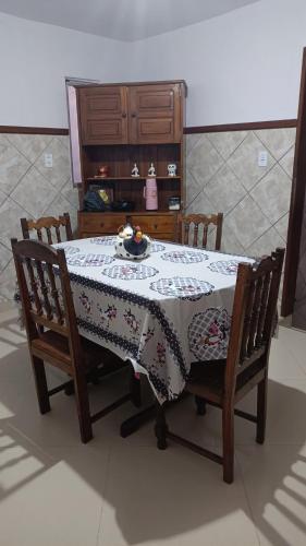 a dining room table with a table cloth on it at aconchego pe na areia in Ilhéus