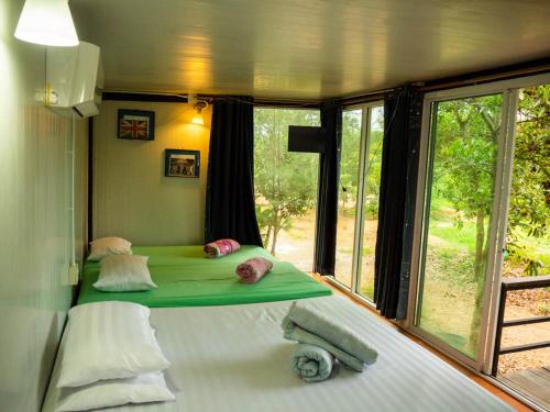 a bed in a room with a window at Beach Box Resort at Rimlay Rayong in Rayong