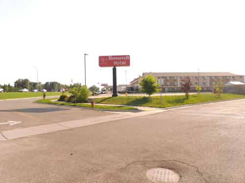 an empty street with a sign for a hospital at Roosevelt Hotel in Williston