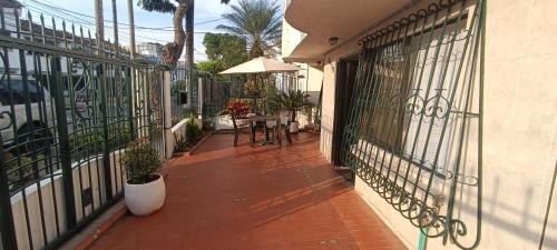 a balcony of a house with a table and chairs at CASA HOTEL FLOR DEL VALLE in Cali