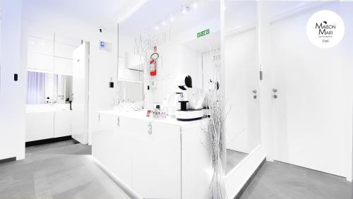 a white bathroom with a sink and a mirror at B&B Maison Mari in Naples