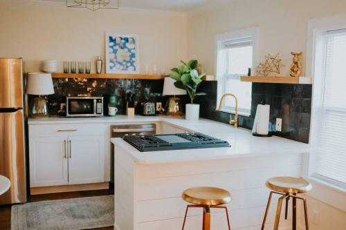 a kitchen with a counter and two stools in it at Dream On – Style & Comfort Near Historic Downtown in Panama City