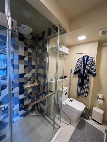 a bathroom with a toilet and a glass shower stall at Marvest Condo Hua Hin for rent in Hua Hin