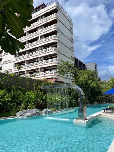 a swimming pool in front of a tall building at Marvest Condo Hua Hin for rent in Hua Hin