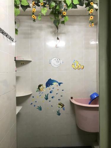 a bathroom with a shower with fish stickers on the wall at 9293 Puncak Nearby Bukit Bendera in George Town