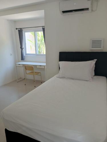 una camera con un grande letto bianco e una scrivania di Beautiful Villa in Sanur a Sanur