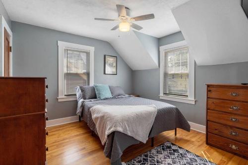 a bedroom with a bed and a ceiling fan at Comfy Cuse home close to SU in Syracuse