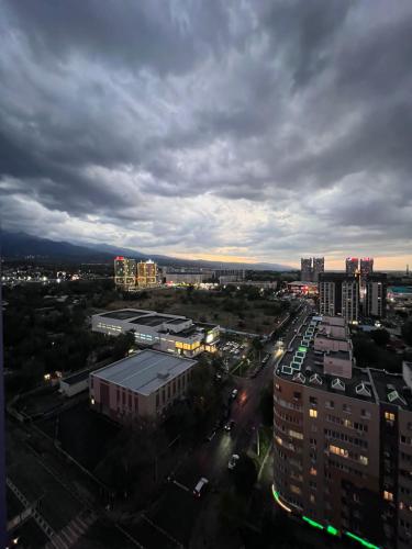 a view of a city with buildings and a cloudy sky at ЖК «Комфорт Сити» in Almaty