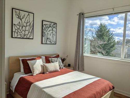 a bedroom with a bed and a large window at A premier luxurious smart condo with parking in Seattle