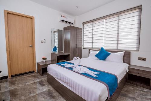 a bedroom with a bed with a stuffed animal on it at A&J Kampot Boutique in Kampot