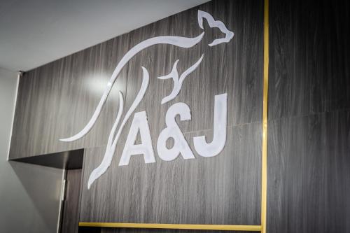 a sign for aaa on the side of a building at A&J Kampot Boutique in Kampot