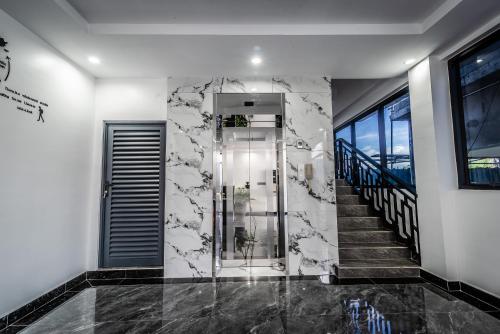 a hallway with a glass elevator in a building at A&J Kampot Boutique in Kampot