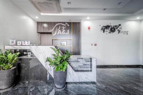 a lobby with two potted plants and a counter at A&J Kampot Boutique in Kampot