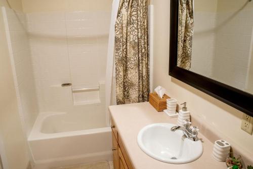 a white bathroom with a sink and a bath tub at Thunder Springs Condo A2-6 in Ketchum