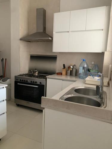 a kitchen with a sink and a stove at Teranga in Dakar