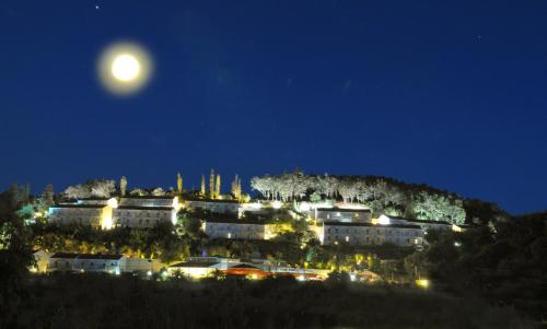 a full moon rising over a city at night at Panorama Sidari in Sidari
