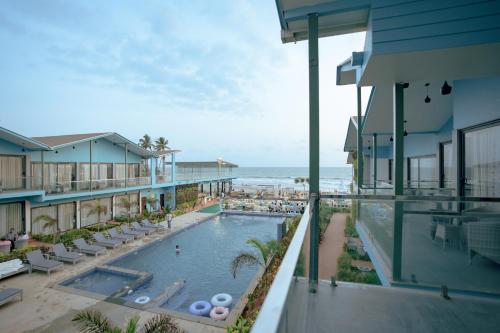 an aerial view of a resort swimming pool and the ocean at TAN-N-SAND in Morjim