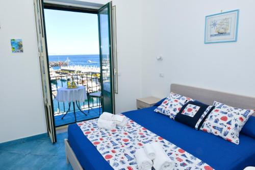a bedroom with a bed and a view of the ocean at La Brezza Home in Piano di Sorrento