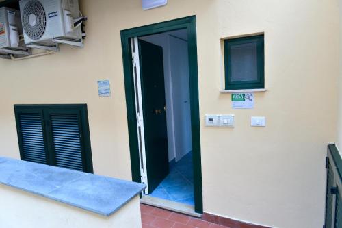 an open door of a building with a window at La Brezza Home in Piano di Sorrento