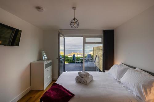 a bedroom with a bed with towels on it at Lanyon in St Ives