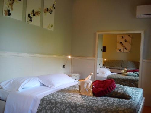 a bedroom with two beds and a mirror at Country House La Perla del Sile in Sant'Elena di Silea