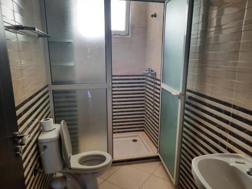 a bathroom with a shower and a toilet and a sink at MAZAPART in El Jadida