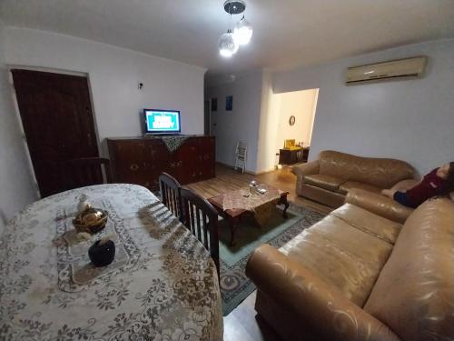 a living room with a couch and a table at Shery''s home in 6th Of October