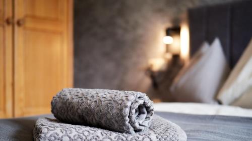 a towel sitting on top of a bed at Jeff's - Rooms with a mountain view in Bad Goisern