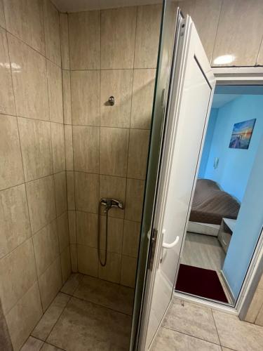 a bathroom with a shower with a glass door at Shabla Lux Guest Houses in Shabla