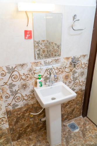 a bathroom with a sink and a mirror at The White House Villa 8 bedroom with Swimming Pool in Kathmandu